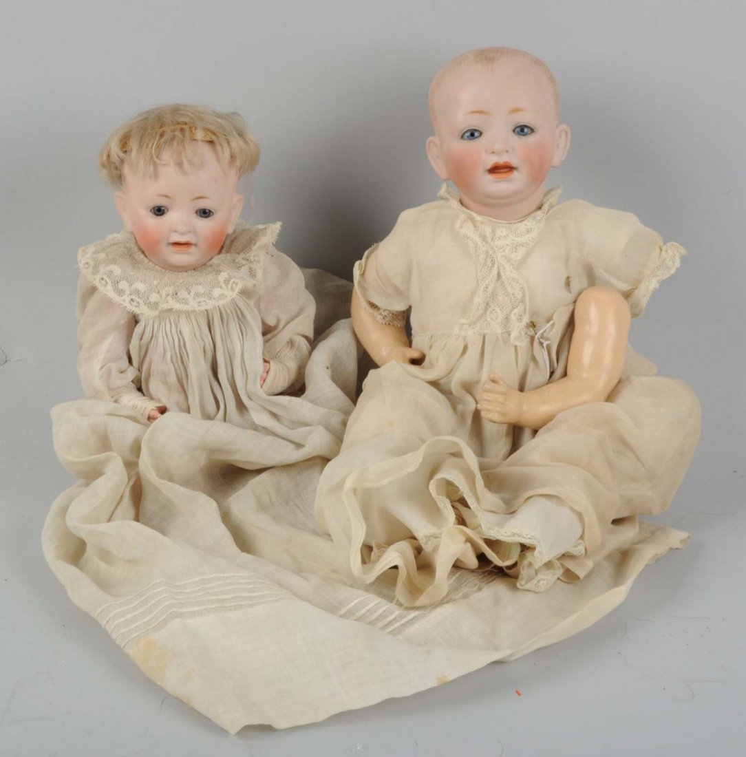 Lot Of 2: German Kestner Bis. Head Char. Babies.: On composition bodies. Marked "JDK 211" and "JDK". Heads look good, one doll needs arm reattached. Nice antique clothing. Condition (Good). Size Largest: 13" T.