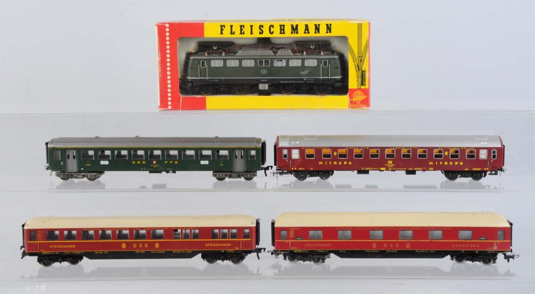 Fleischmann Locomotive and 4 Passenger Cars.: Fleischmann German outline diesel electric powered locomotive, complete like new in original box. Two German passenger car, maroon with tan roof, complete and in excellent condition. Swiss commuter ca