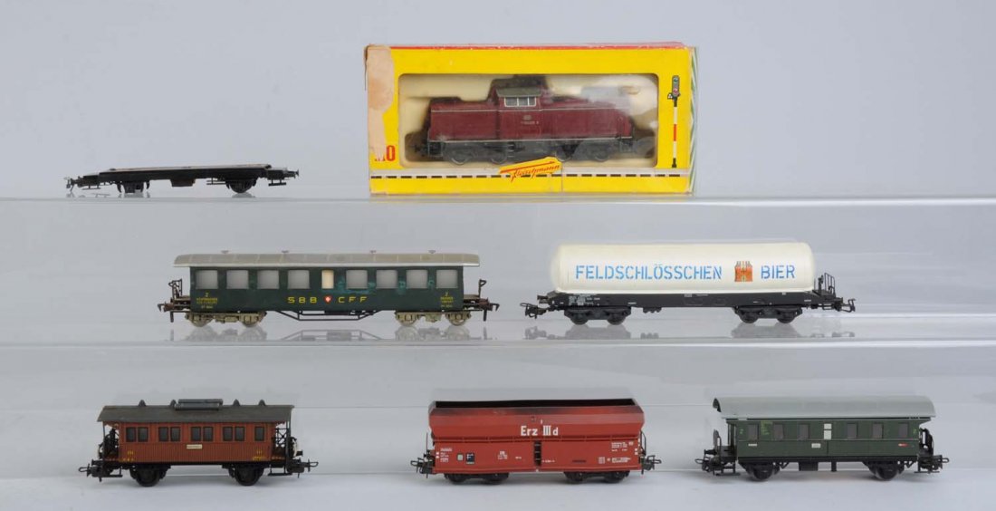 Lot of 7: Fleischmann & Marklin Assorted Trains.: Fleischmann diesel locomotive complete and in excellent condition in original box. Fleischmann Swiss passenger car complete and in excellent condition. Marklin Feldschlosschen tank car two broken step