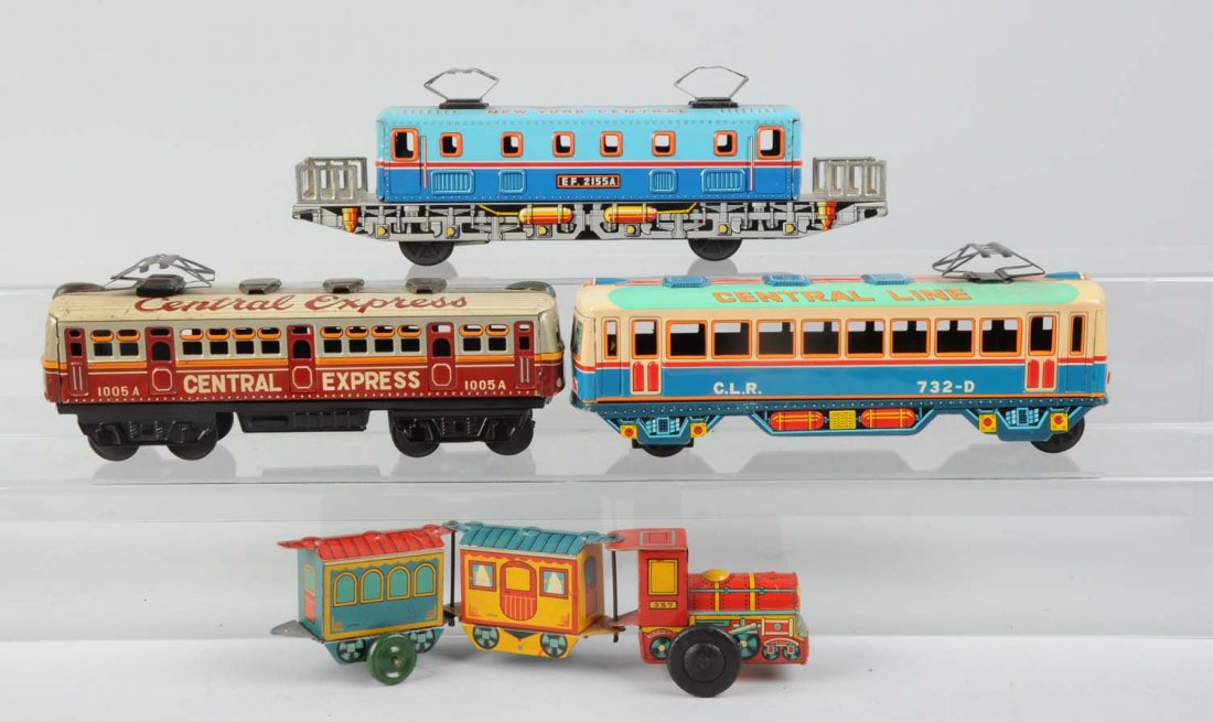 Lot of 4: Japanese Tin Toy Train Cars.: Includes: One tin wind - up articulated toy trains, works well marked trademark Y in a leaf design, Japan, missing a stack. Blue NYC electric outline, this locomotive is marked TN made in Japan, compl
