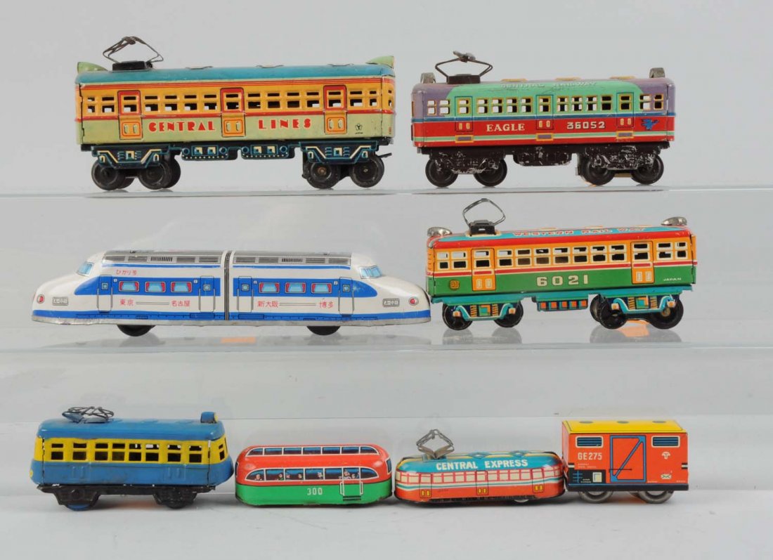 Lot of 8: Assorted Japanese Tin Toy Trains.: Includes: One Central Lines friction drive locomotive, friction motor is not working, otherwise complete and all original, clean and attractive, and in excellent condition. Eagle Central Railways pass