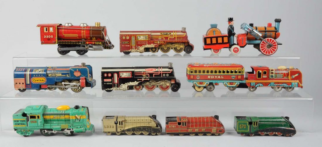 Lot of 10: Mostly Japanese Tin Litho Toy Trains.: Lot consists of: Royal Special Line tin litho friction drive made by T.N. Japan that is complete, all original, clean, and attractive; black Peace Line tin litho toy train that is complete, all origin