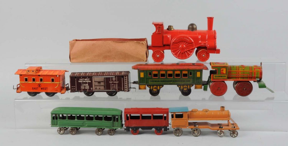 Nonpareil, Straus and Other Toy Trains.: This lot includes: A Nonpareil steam locomotive, complete and all original. One Japanese tin litho east west transcontinental box car, this car has some scratches on the roof. A Strauss all aboard lim