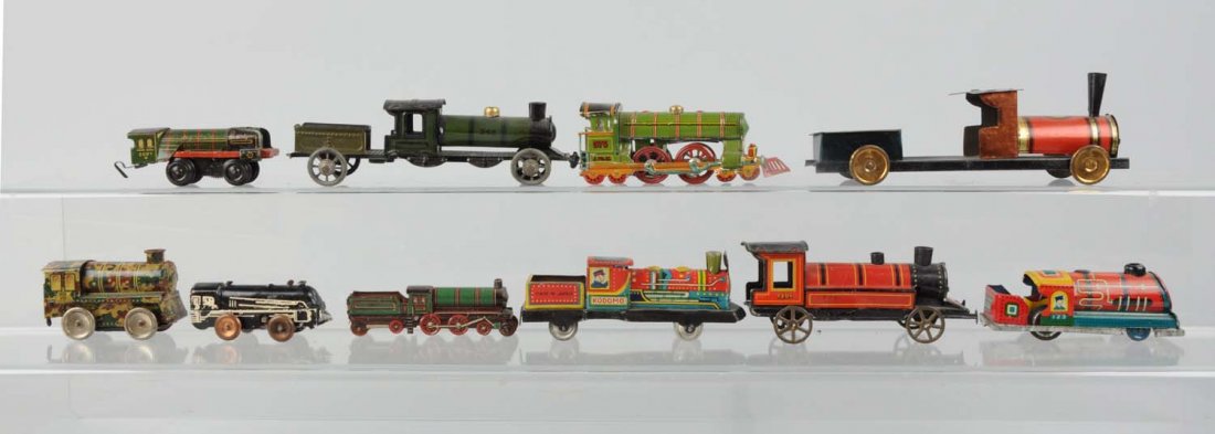 Lot of 10: Toy Trains by Various Makers.: Includes: a multi colored steam locomotive and tender, no mark found but i believe probably early American. Green and black steam four wheel locomotive marked made in Germany, probably a penny toy in 