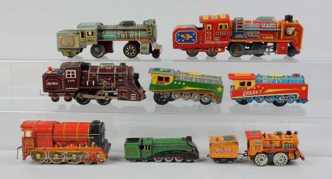 9 Assorted Tin Litho Trains Mostly Japanese.: Lot includes: One tin litho Indian train, friction drive registered train mark is an M in a triangle, Japan. Maybe interest to know this toy has an Indian head on the smoke deflector and on what would