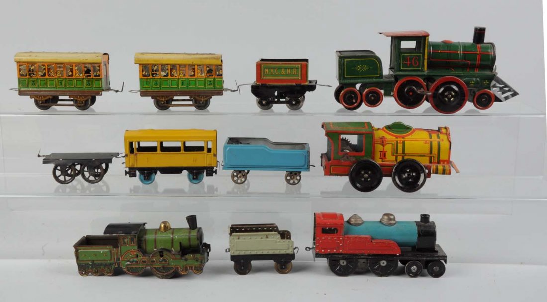 Lot of 11: Assorted Toy Trains.: Includes: One wind - up steam locomotive, wind - up mechanism is broken and missing a stack, Chein made in U.S.A. Green wind - up locomotive tin litho wind - up mechanism works says Strauss, is comple
