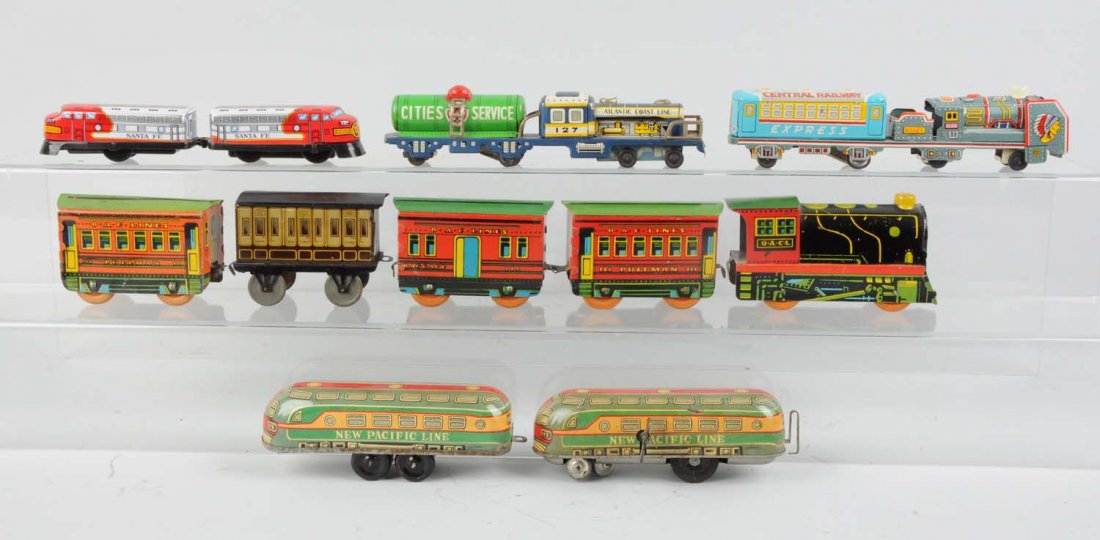 Assorted Tin Litho Toy Trains Mostly Japanese.: Includes: One tin litho push toy steam locomotive, marked O. A. C. L, excellent condition. One four wheel passenger coach European outline, marked G. P. N Co. Excellent condition. One O. A. C. Lines b