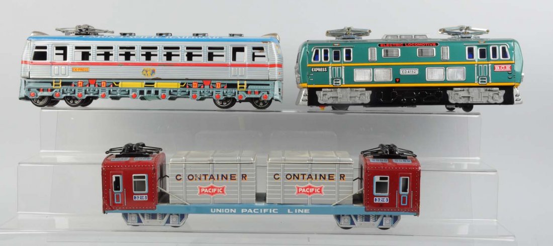 Lot of 3: Japanese Tin Litho Toy Trains.: Includes: Union Pacific container train, complete and original, very clean and attractive and in excellent condition. Union Pacific Railroad Express train, friction drive. Electric locomotive express 
