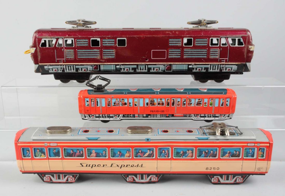 Lot of 3: Tin Litho Toy Trains.: Includes: One purple tin litho toy train, friction, marked Japan, scratched and worn, good condition. A friction drive commuter marked Y in a leaf design made in Japan, excellent condition. Super expr