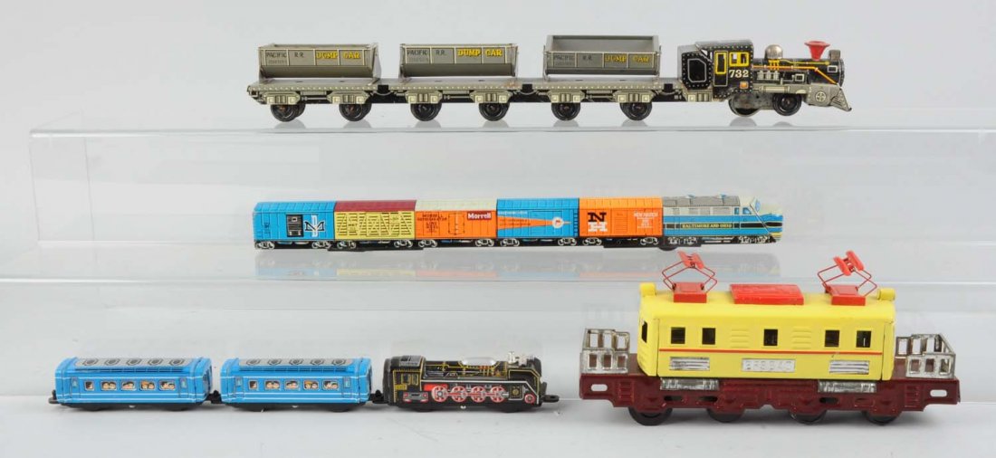 Lot of 4: Assorted Japanese Tin Litho Toy Trains.: Small friction drive locomotive, complete and in excellent condition. One Pacific Railroad dump car train, friction motor is very stiff and hard to move, otherwise complete and all original, clean and