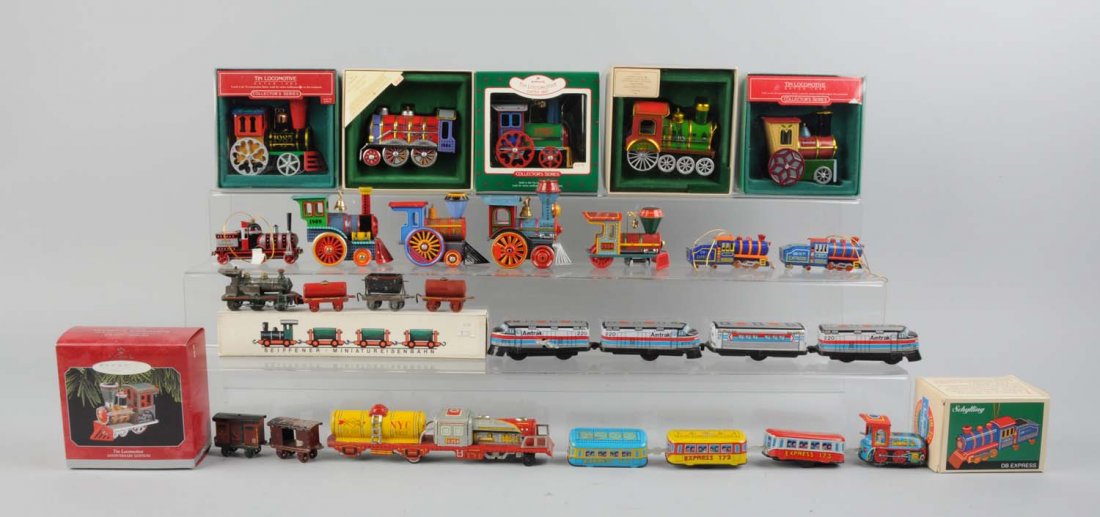Large Lot of Hallmark, Japanese Tin, Train Toys.: Lot includes: Hallmark 1985 steam locomotive, 1986, 1984, 1987, 1983. All have original box, one is missing a box lid. One Hallmark Keep Sake steam locomotive in box. One tin litho No. 173 express tra