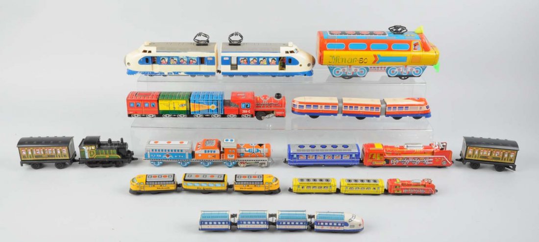 Lot of 13: Assorted Modern Era Tin Litho Trains.: Includes: Plastic streamliner, a tin litho masuaya made in Japan, friction toy train in excellent condition. A friction Ichico made in Japan, locomotive and passenger car. Minar - 80 tin litho and pla