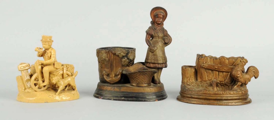 Lot of 2: Pottery Match & Cigarette Holders.: With strikers. Lot includes a man on a bike with a dog, with a minor base chip; a lady with basket that has a base chip; and a rooster crowing. Condition (Good - Excellent). Size Largest: 9" T.
