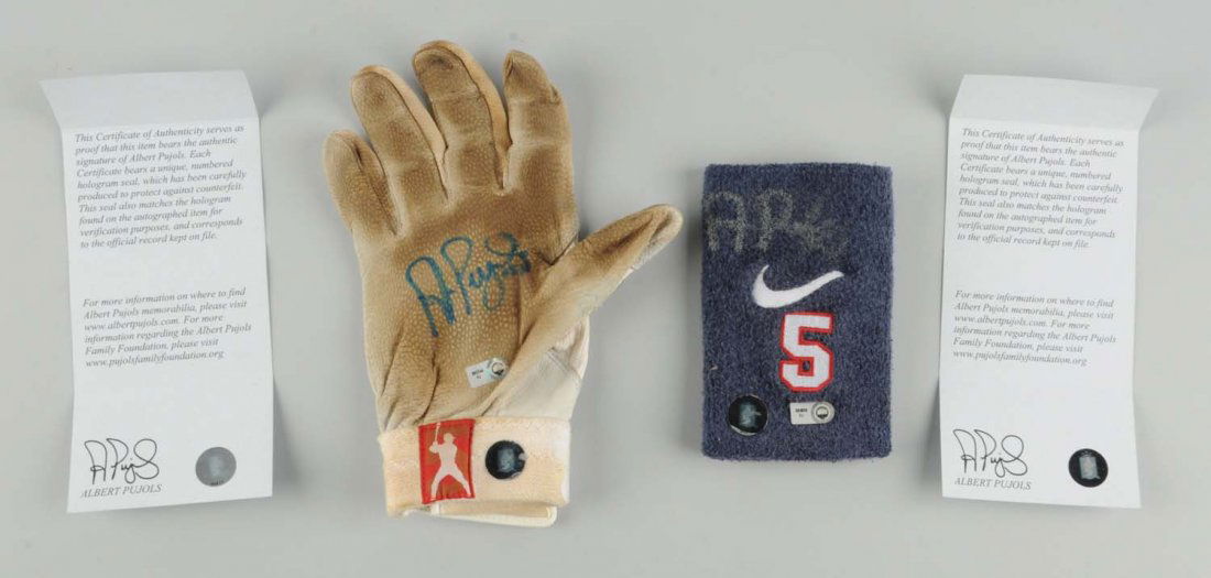 Autographed Albert Pujols Baseball Items.: Game used items. One is a right handed batting glove which has his name across the Velcro strip, and also a sweatband with his number on it. Both are signed, and come with certificate of authenticity