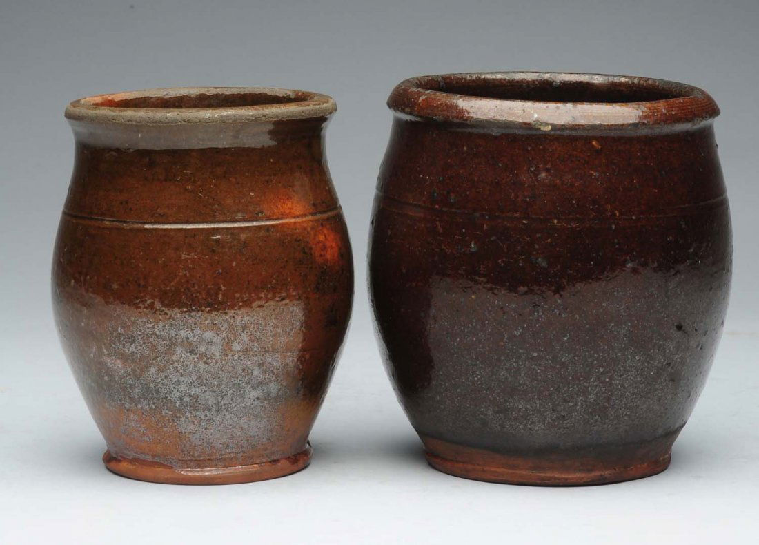 Lot of 2: Small Redware Crocks.: Each of these two pots have a concentric line. One has an in-the-making glaze scrape. Condition (Very Good). Size Largest : 6 -1/2" L.