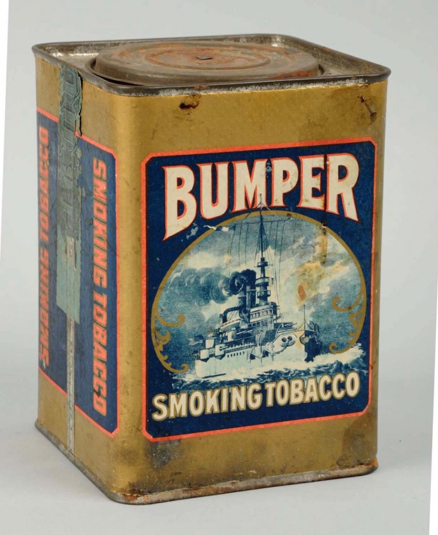 Bumper Smoking Tobacco Tin.: This tin has a paper label. The label has minor wear and soiling. Great depiction of and early battleship. Condition (Very Good Plus). Size 6 -1/2" T.