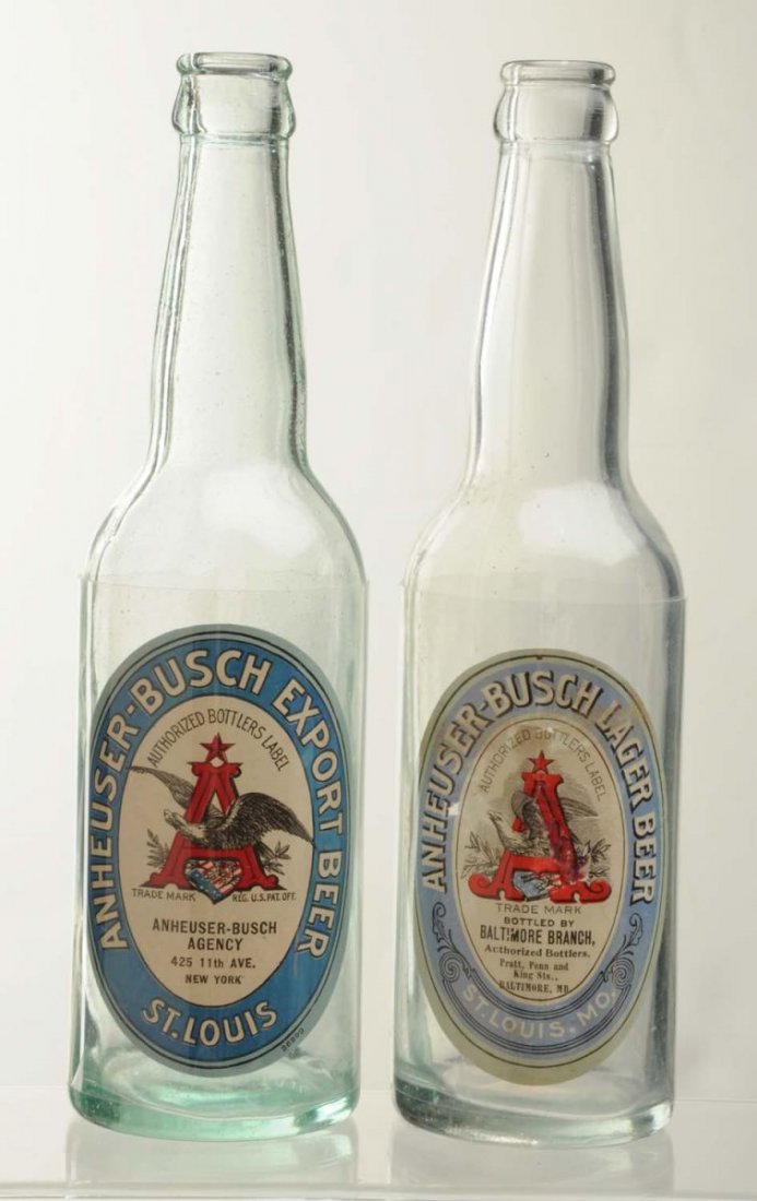 Lot Of 2: Pre-Prohibition Anheuser-Busch Bottles.: With labels. This lot includes a bottle with an Anheuser-Busch Lager Beer label with fading and wear, and an Anheuser-Busch Export Beer label. These labels may have been attached at a later date. Cond
