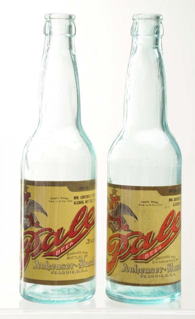 Lot Of 2: Anheuser-Busch Beer Bottles.: Pre-Prohibition. These two bottles both includes an Anheuser-Busch Pale Beer label. One label has light wear and creasing and the other is very clean. Both may have been attached at a later date. Cond