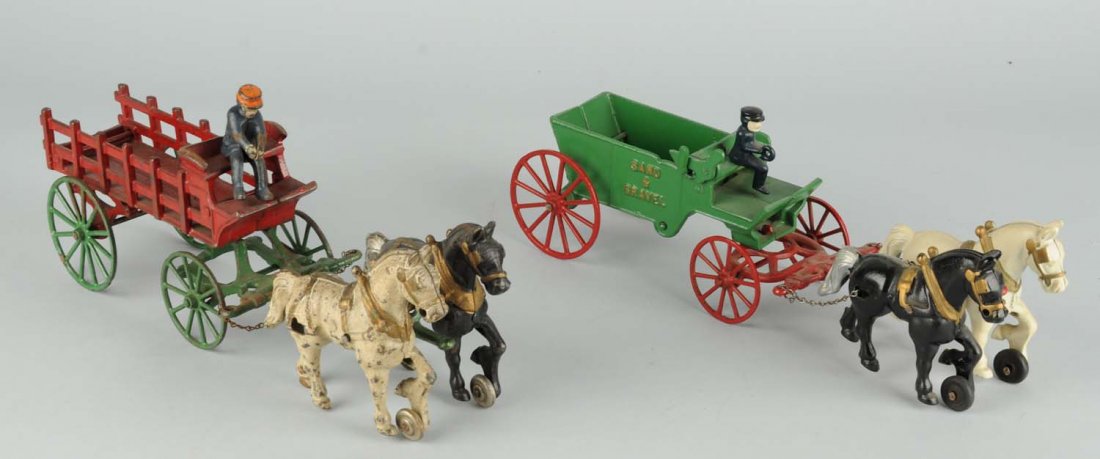 Lot Of 2: Cast Iron Horse Kenton Drawn Wagon Toys: One is a "Sand & Gravel" and the other is a stake back. Both look to have original driver and are pulled by two horses. Condition (Very Good - Excellent). Size 16" L.