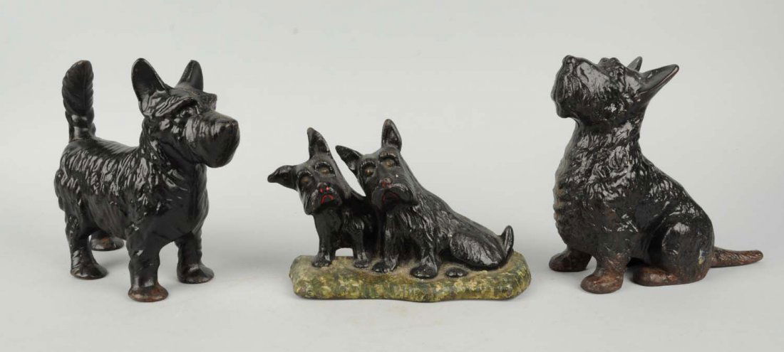 Lot Of 3: Cast Iron Scottie Doorstops.: Includes: Texaco Scotties, National Sewing Machine Co.; Sitting Scottie, Spencer; Standing Scottie, repainted. Condition (Very Good). Size Largest: 8 - 1/4" T.