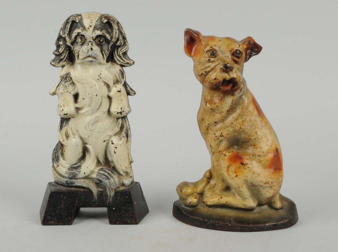Lot Of 2: Cast Iron Assorted Dog Doorstops.: Includes: Mutt and bone, Creations; Japanese Spaniel, Judd Co. Condition (Good - Very Good). Size Largest: 9" T.