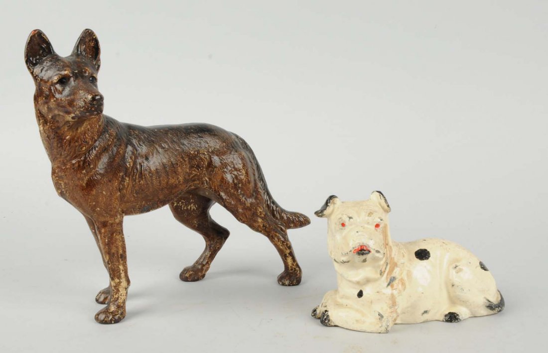 Lot Of 2: Cast Iron Assorted Dog Doorstops.: Includes: German Shepherd, Hubley; lying down Bulldog, early repaint. Condition (Very Good). Size Largest: 9 - 3/8" T.