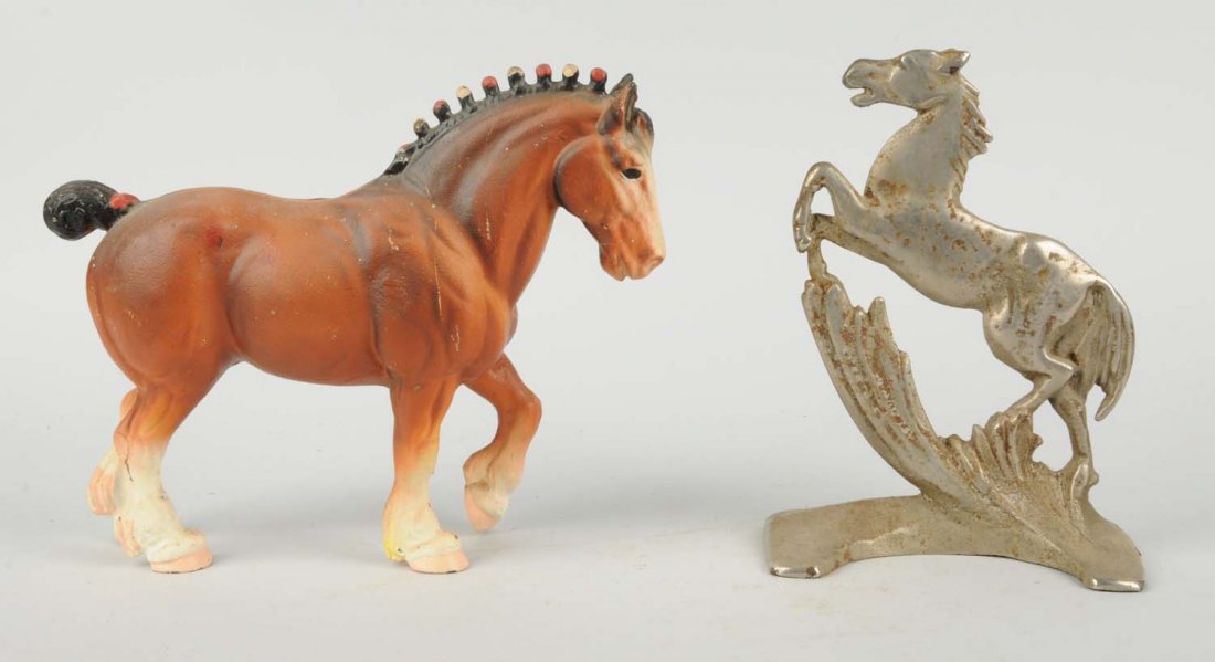 Lot Of 2: Cast Iron Horse Doorstops.: Includes double-sided rearing horse, nickel over cast iron; Reproduction Clydesdale work horse. Condition (Very Good). Size Largest: 8 - 3/4" T.