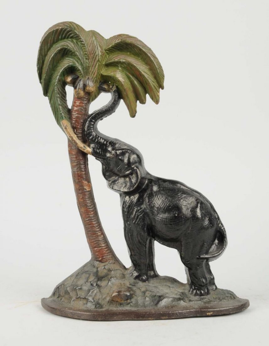 Cast Iron Elephant by Coconut Tree Doorstop.: National Foundry, No. 13. Repainted. Condition (Good). Size 14" T.