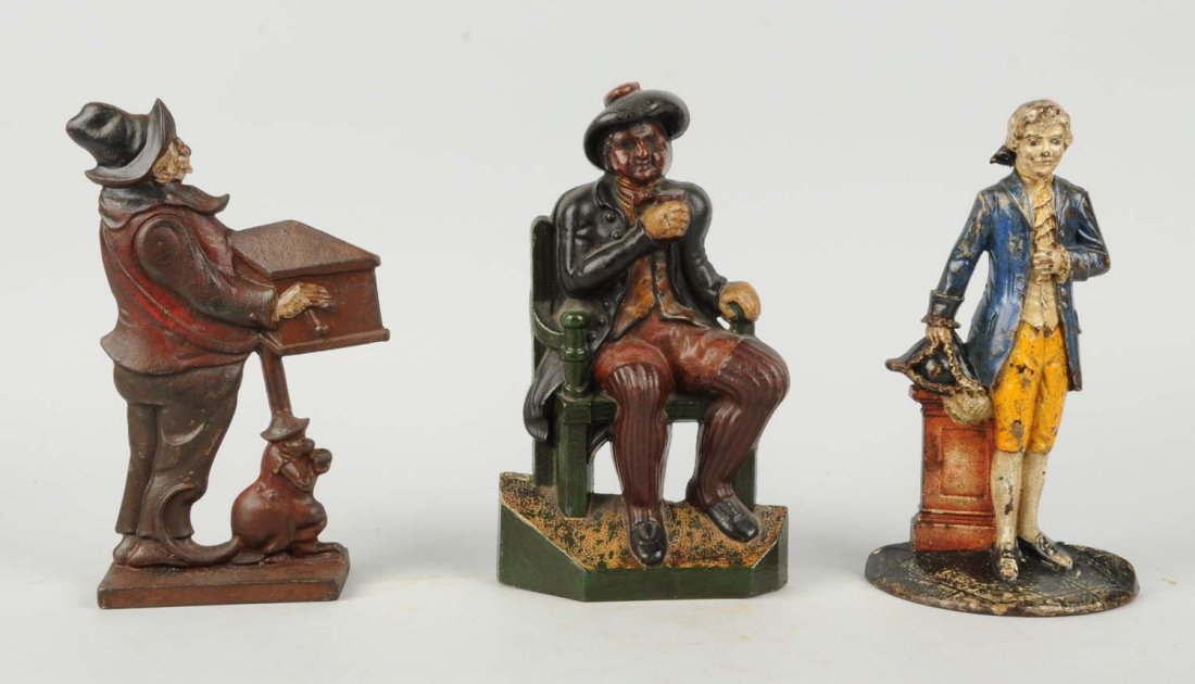 Lot Of 3: Cast Iron Assorted Figure Doorstops.: Includes: Colonial Lawyer, Waverly Studios; Monkey and organ grinder; Man in chair with ale mug, English. Condition (Good - Excellent). Size Largest: 10 - 1/4" T.