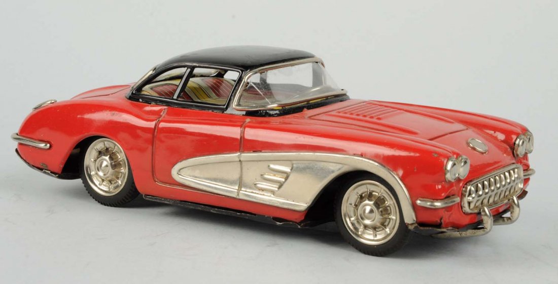 Japanese Tin Litho Friction Toy Corvette.: Made by Yonesowa. Two toned red with black roof, some scratching and denting to roof. A lot of scratching to bottom of car. Condition (Good - Very Good). Size 9 - 1/2" L.