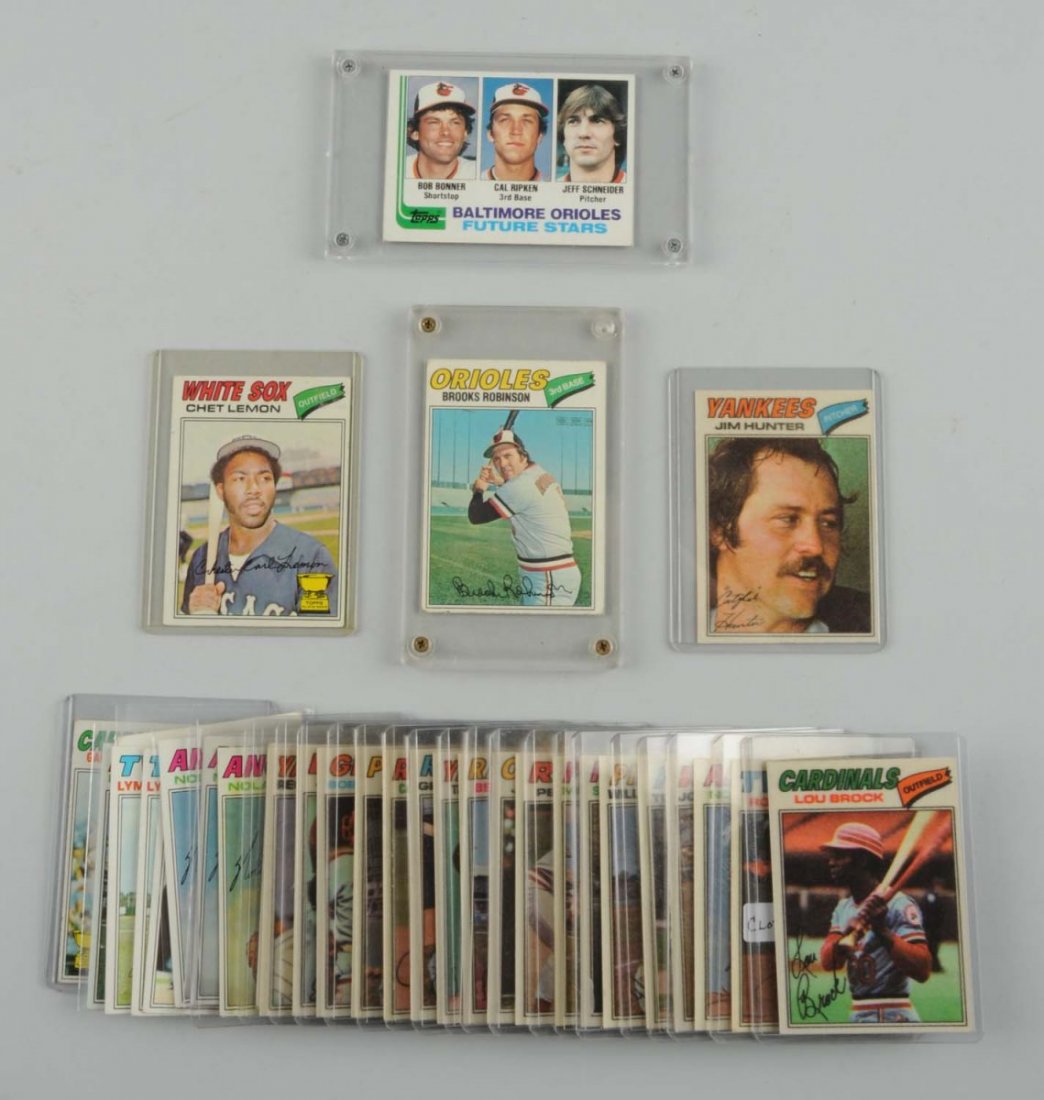 Lot Of 35: 1977 Topps Cloth/ Reg Baseball Cards.: 19 cloth cards, including Hall of Famers Lou Brock, Jim Hunter, Steve Carlton, and others. 16 regular Topps cards including one No. 21 rookie card of Cal Ripken Jr., three No. 650 Nolan Ryan cards. Pl