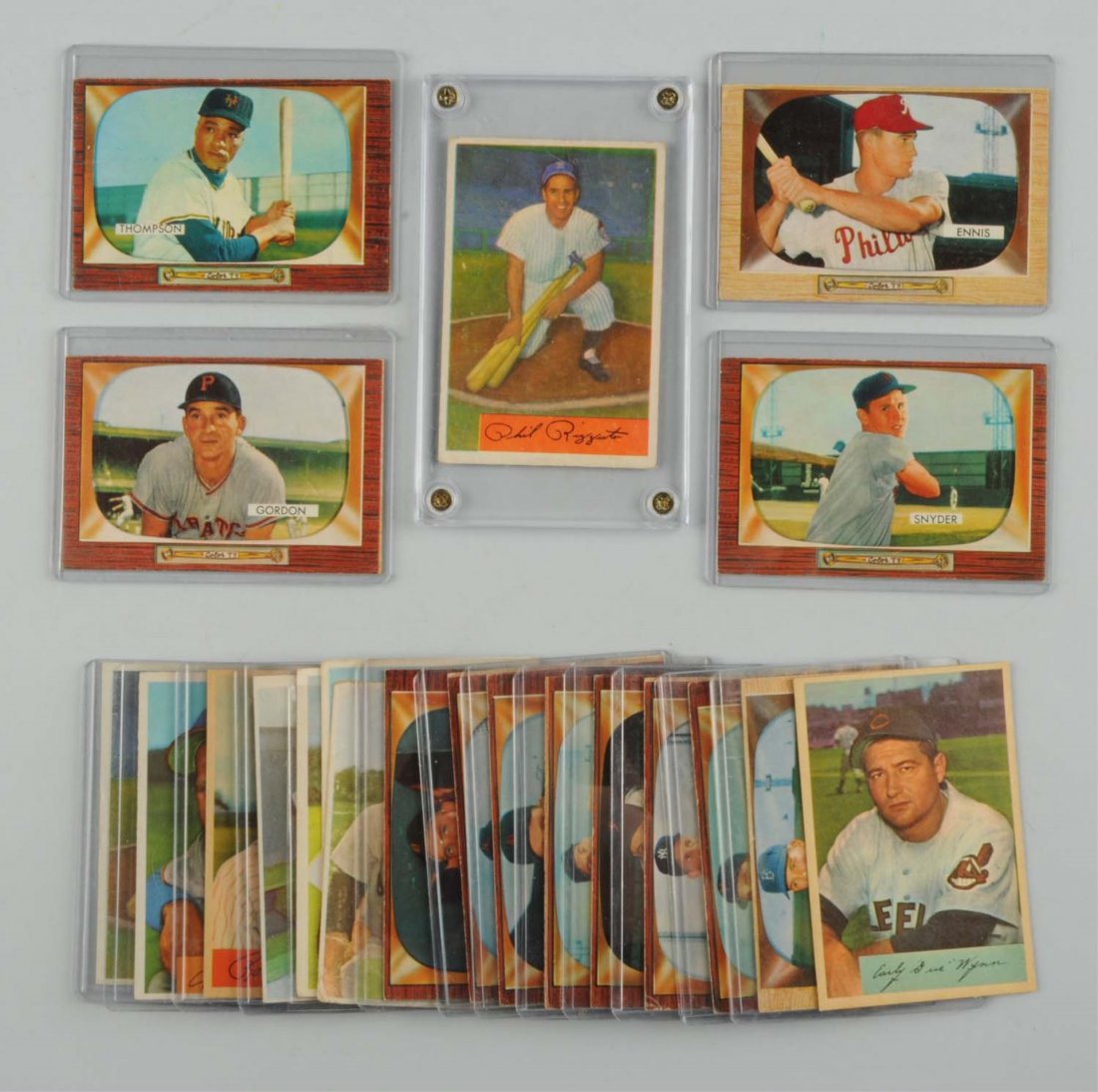 Lot Of 21: 1950's Bowman Baseball Cards: There are nine 1954 cards including two No. 1 Phil Rizzuto cards, both of which have some creasing and edge wear. Other Hall of Famers include No. 132 Bob Feller, No. 95 Robin Roberts. Also 12 1955 Bo
