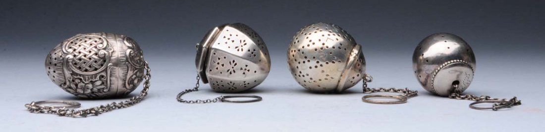 Group Of 4: Sterling Tea Balls.: A group of sterling tea balls, including a heavy cast egg-shaped one with flowers and trelliswork panels, unmarked probably Hanau; a panelled acorn-form one; and two spherical ones, one Whiting. Heigh