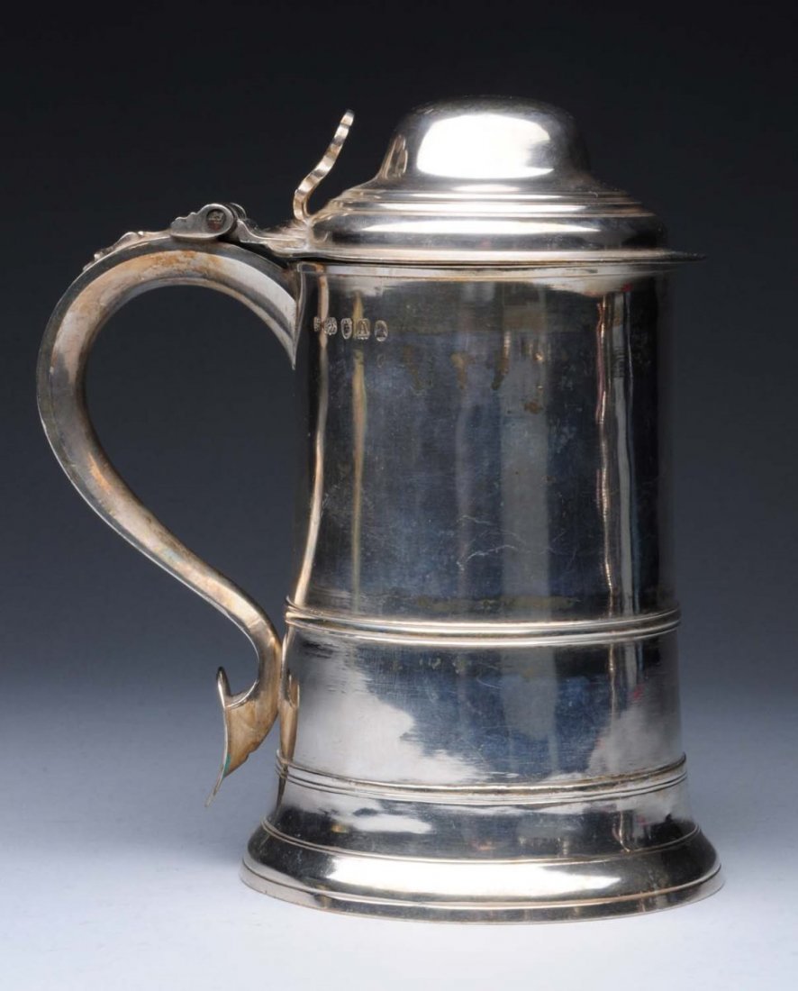 English Silver Tankard.: George Smith & Thomas Hayter, London 1796 cylindrical with a molded waistband, domed lid, pierced thumbpiece and scroll handle. Marked on side. Height: 8 in. Weight: 22 ozt - signs of use and wear - h