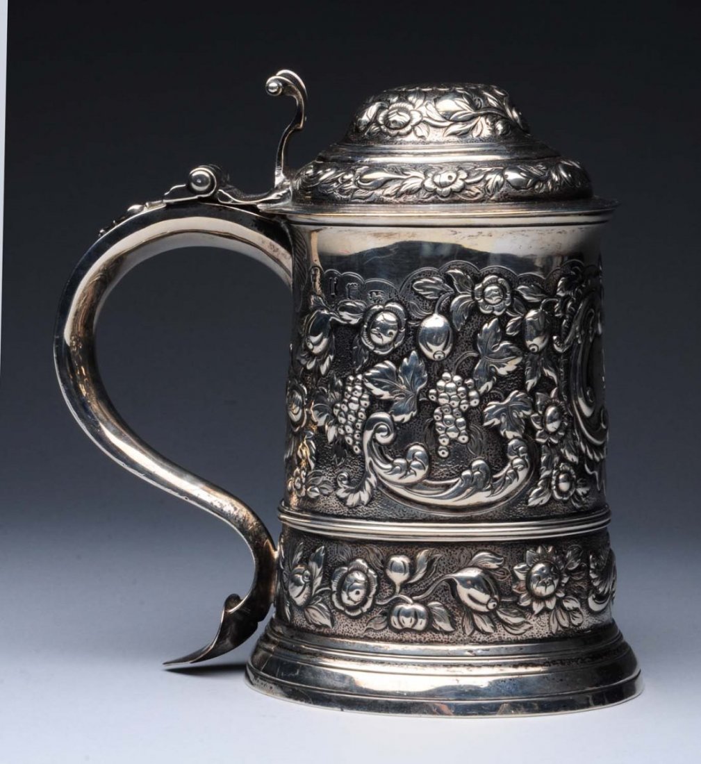 English Silver Tankard.: London 1753 probably William Shaw & William Priest, with a domed lid, slightly tapering sides over a molded foot, and a scroll handle, all later-chased with scrolls and fruit on a matted ground, the f