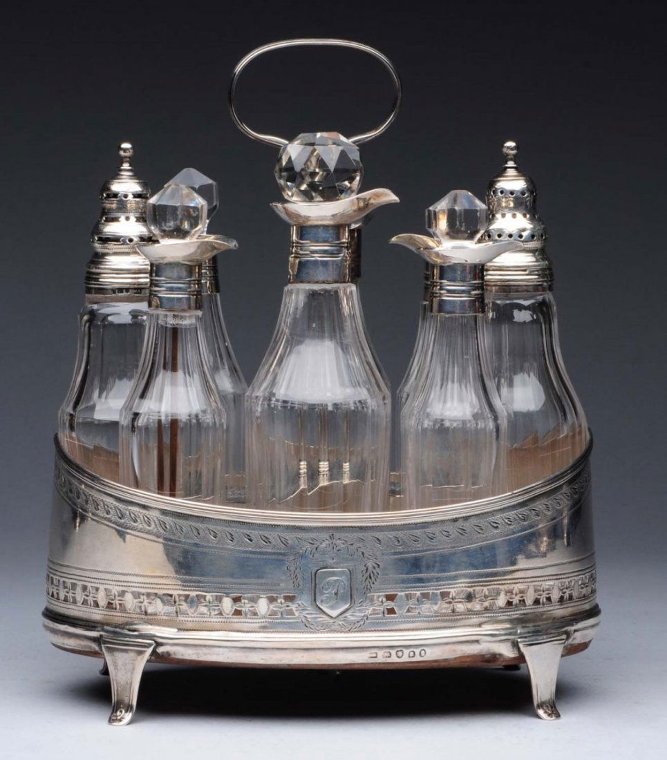 English Silver Cruet Stand.: William Abdy, London 1796, oval with straight pierced and engraved sides around 8 bottles and a shaped center with a loop handle. Marked on base; bottle mounts; and center support. Repairs. Height: 10