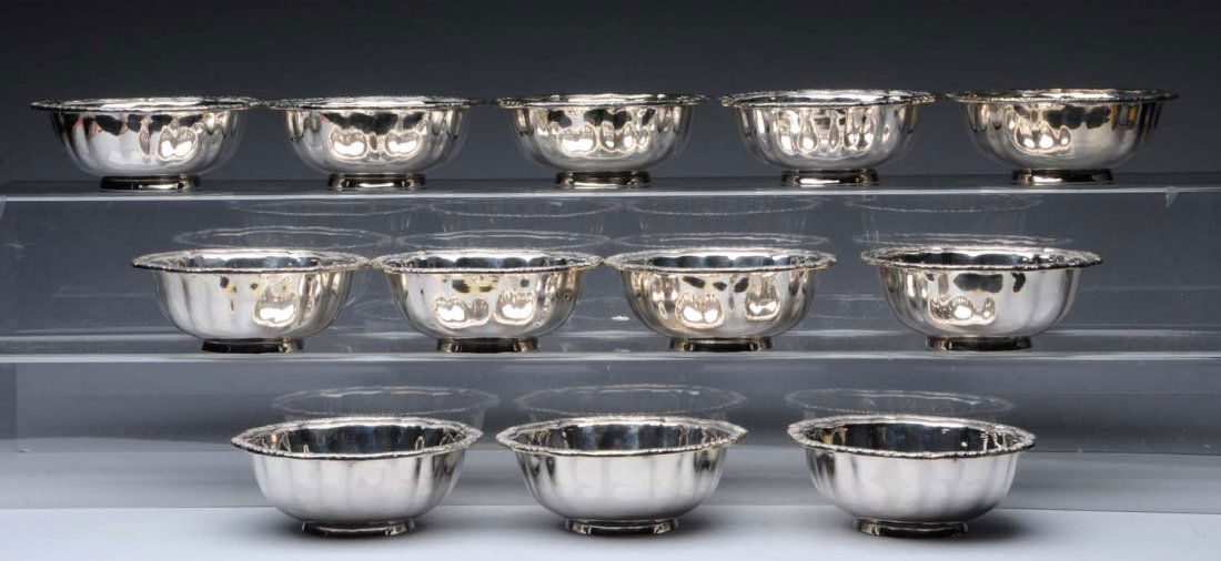 Set of 12 Silver Finger Bowls by Paul Storr.: each with a wavy gadrooned rim over slightly crimped sides tapering to a low foot. The underside of each rim bearing spurious London hallmarks. Diameter: 5 in. Total weight: 82 ozt - marks under rims
