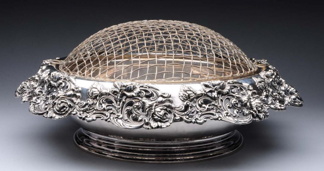 Large American Sterling Center Bowl.: Black Starr & Frost, circular with a chased and pierced and rim with scrolls and floral sprays and a plain center. With a plated liner and metal grill. Diameter: 18 in. Weight excluding liner and gril