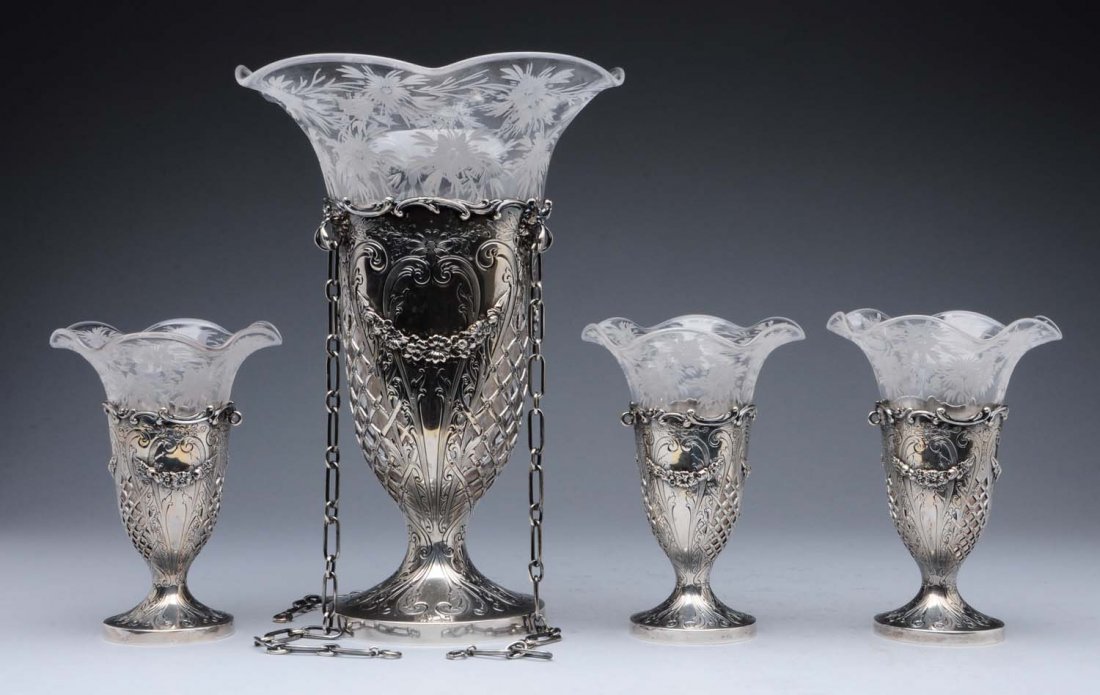 American Sterling Hanging Vase & 3 Smaller Vases.: and three smaller table vases, Mauser, each vase- form with a chased and pierced body with swags and scrolls and a floral cut glass insert with a flaring rim, the larger with chains. .Height of larges