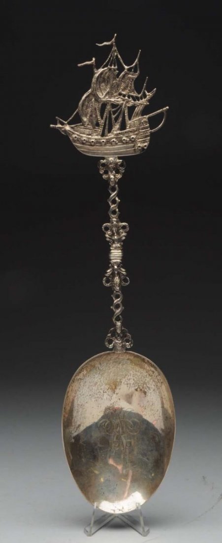 Large Dutch Silver Figural Spoon.: Circa 1909, with a cast finial in the form of a sailing ship, and a broad plain oval bowl engraved with initials and a date inside and a crest on the outside. 2nd standard and export marks. Total weig