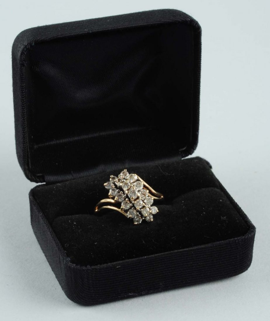 Diamond Cluster Ring.: Stamped 10K, size 8-1/2, .97 estimated total diamond weight. I-J-K color, I1 clarity. 2.3 dwt. Condition (Very Good).