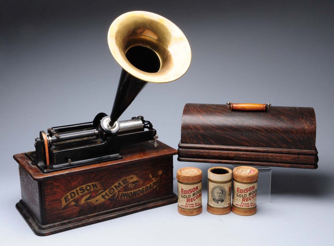 Edison Cylinder Phonograph With Horn.: This phonograph has some wear to the front label. Fairly clean otherwise. Horn and lid are included along with numerous cylinders. Condition (Very Good Plus). Size 16" L.