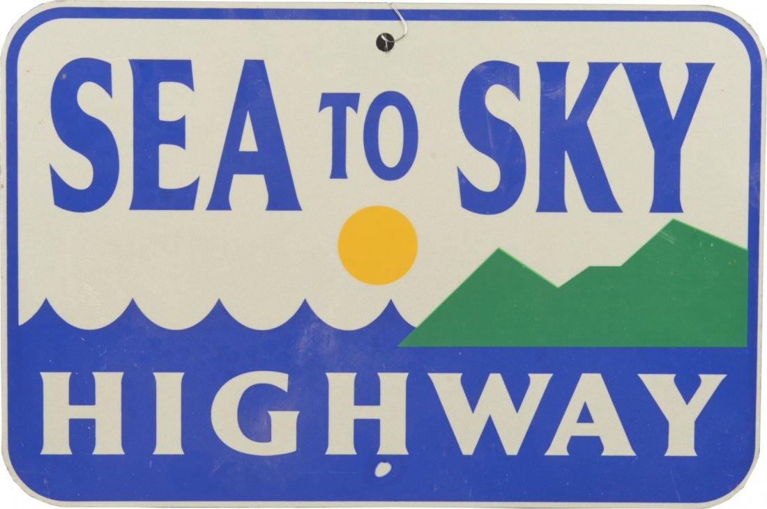 Single Sided Sea To Sky Highway Sign: This metal road sign shows minimalist graphic of the ocean, sun, and mountains. Sign does show one flaw below the "H" in Highway. Rated 9. Condition (Near mint). Size 12" x 17-1/2"