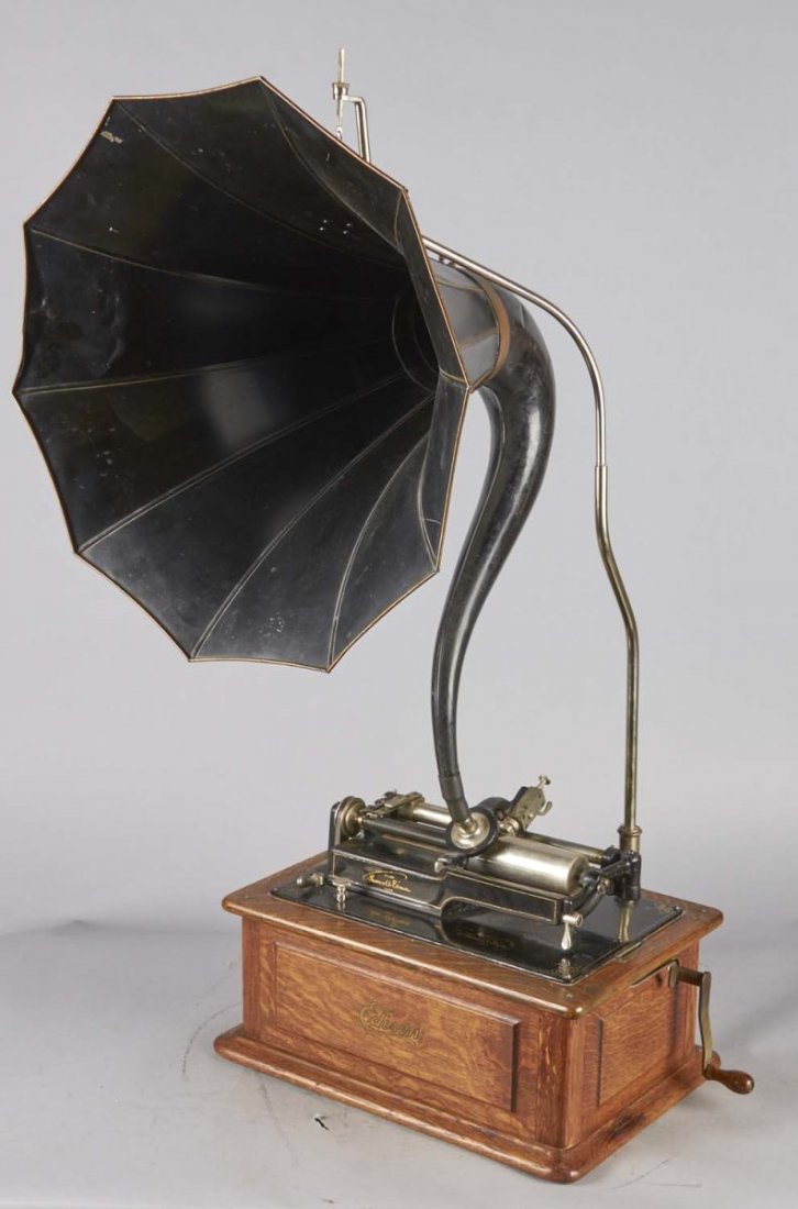 Edison Cylinder Player: This machine plays two and four minute wax cylinders. This lot includes cylinder records and signet horn with original decal. Condition (Excellent). Size 15" x 12"