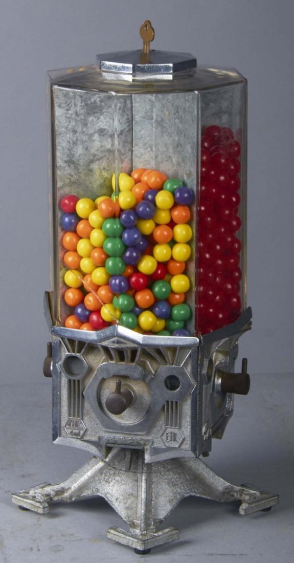 1 ¢ Penny King 4 In 1 Countertop Vending Machine: This rotating art deco style machine is marked "The 4 In 1" and "EHL", the initials of Earl H. Lohmuller, owner of Penny King System. Each side shows the last coin with product. Includes key and origi
