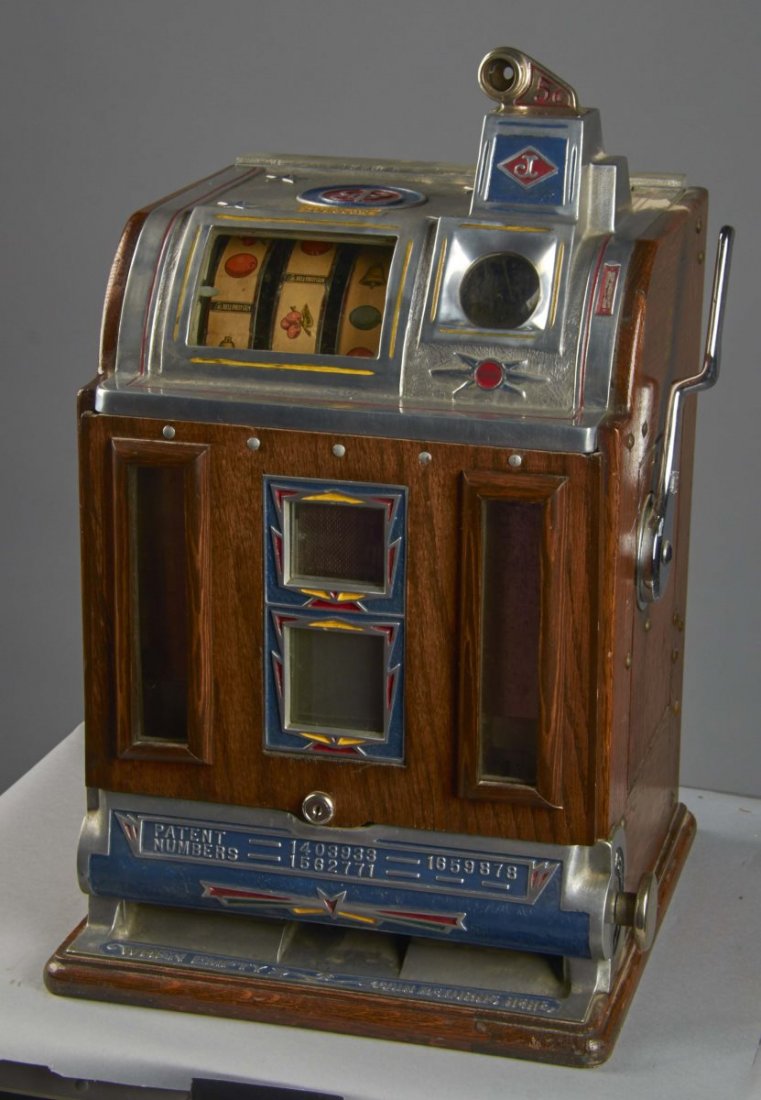5 ¢ Jennings Victoria "B" Vendor Slot Machine: 5 cent O.D. Jennings Victoria front vendor gooseneck bell slot machine. This machine has several of the markings of Victoria Model B "Art Deco" machine, but also has a wood front double vendor. Circa
