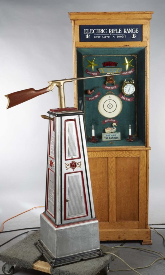 1 ¢ Electric Rifle Range Arcade Game: Shooter uses rifle to animate several targets when shot. Manufactured by the Automatic Target Machine Co. One iron door is new. Rifle powers up and shoots but targets have not been tested. Includes ke