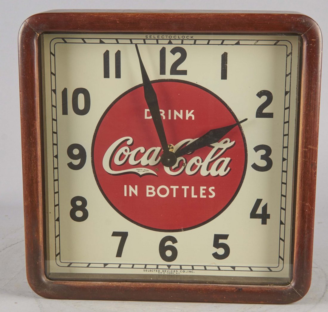 Electric Coca Cola Clock: Clock has two hands: Hours and Minutes. "Drink Coca Cola in Bottles." Manufactured by the Selected Devices Co. Inc. of New York. Circa 1939. Condition (Near Mint). Size 16" x 16"