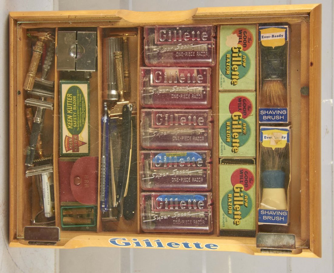 Gillette Wood And Glass Countertop Razor Display: Full of product., including approximately 10- razors in boxes, 9- loose razors, 7- straight edge razors, 2- Ever Ready Shaving brushes, and 1- More Edge blade dispenser. Much is new old stock. Circa 1