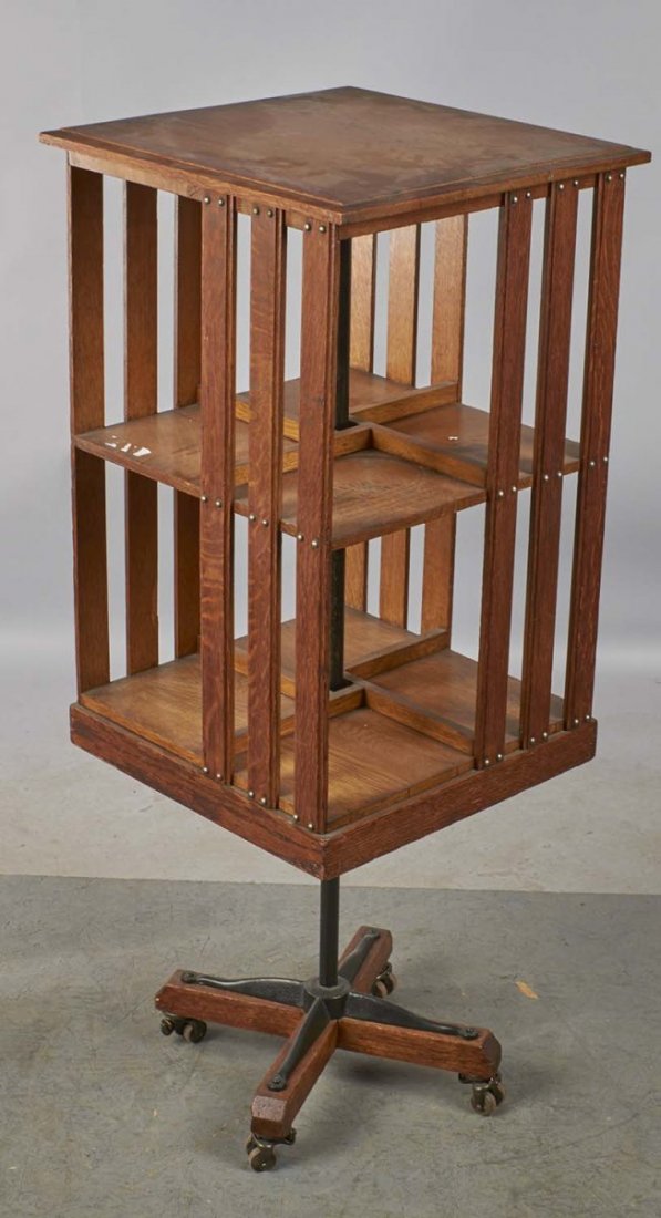 Antique Danners Revolving Oak Book Case: Book case stands on wood wheeled base. Rubber stamped with latest patent date of May 16, 1877 and manufactured only by John Danner Mfg. Co. Condition (Excellent). Size 45" x 18" x 17-3/4"